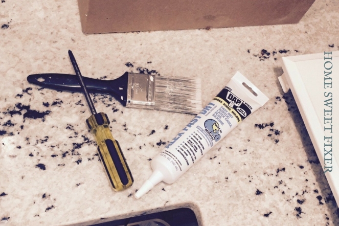 Paintbrush, Screwdriver and White Fast Dry Caulk Used to Update the Kitchen Cabinets from Basic Oak to Modern White Farmhouse Inspired Cabinets.